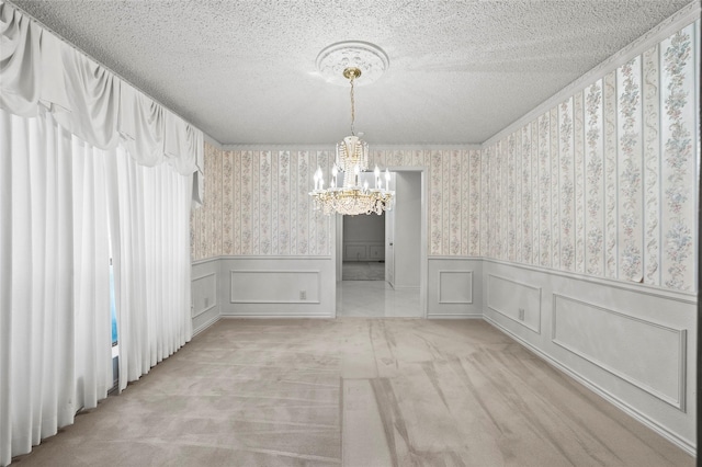 4247 Blackheath Rd, Dallas, TX 75227 - spare room featuring light carpet, a notable chandelier, and a textured ceiling