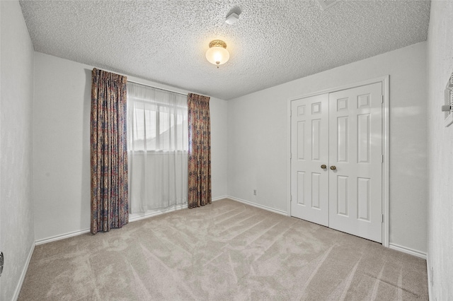 4247 Blackheath Rd, Dallas, TX 75227 - unfurnished bedroom with a closet, light carpet, and a textured ceiling