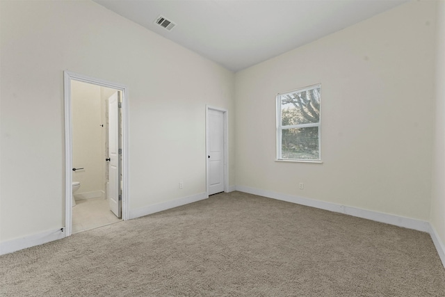 unfurnished room with light carpet