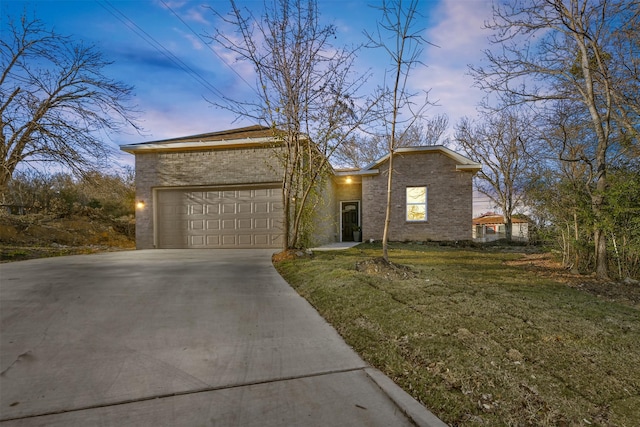 view of front of property with a yard and a garage