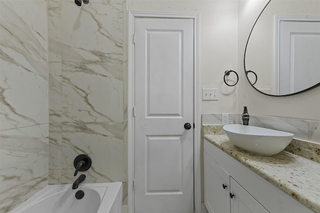 bathroom with vanity and tiled shower / bath combo