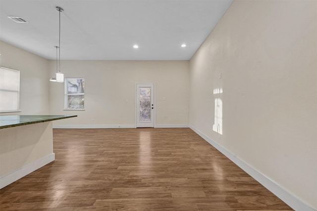 unfurnished living room with dark hardwood / wood-style flooring