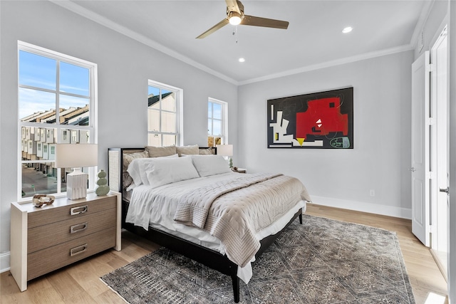 bedroom with light wood-type flooring, ceiling fan, and ornamental molding