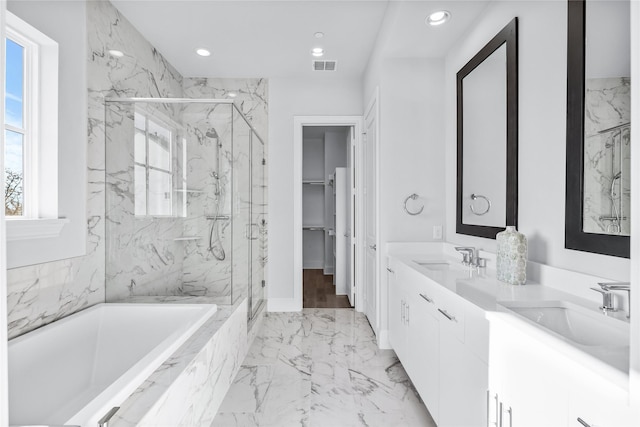 bathroom featuring separate shower and tub and vanity