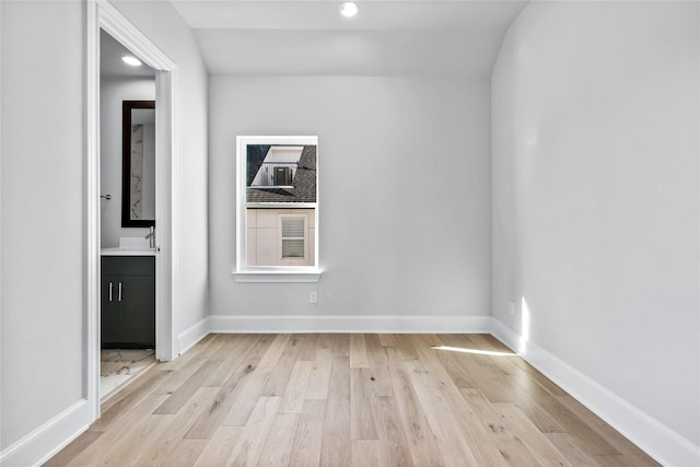 spare room with light wood-type flooring and sink