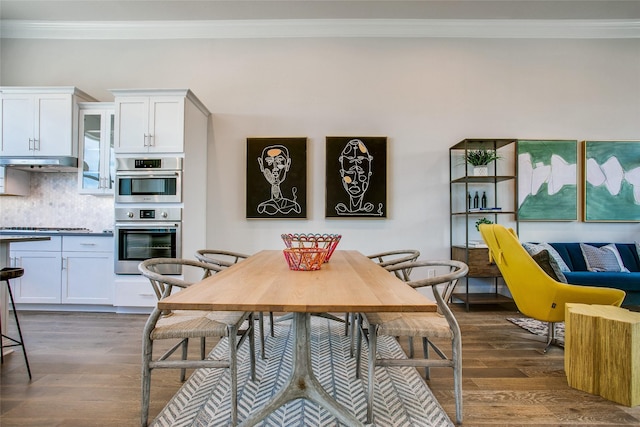 dining area with crown molding and dark hardwood / wood-style floors