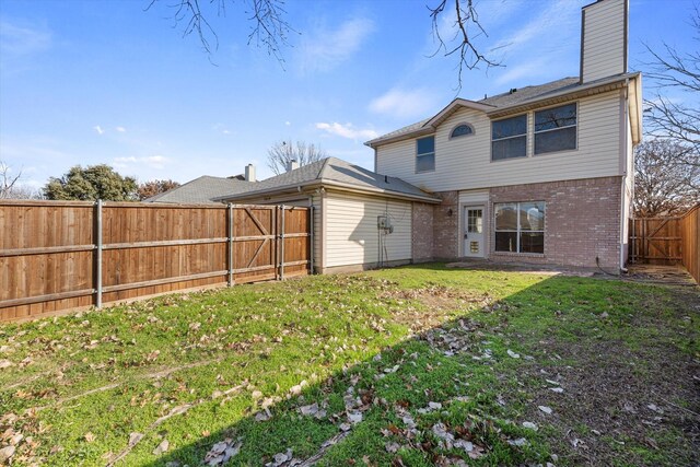 rear view of property featuring a yard