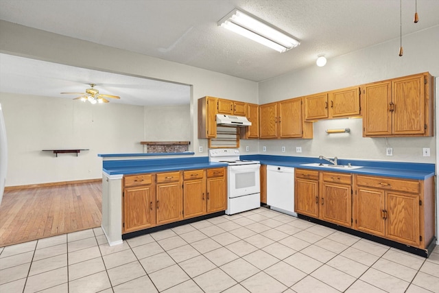 kitchen with white appliances, sink, ceiling fan, light tile patterned floors, and a textured ceiling