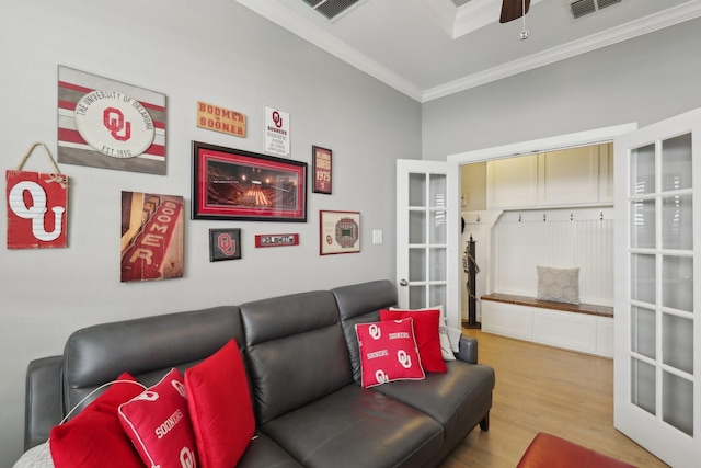 living room with ceiling fan, french doors, light hardwood / wood-style flooring, and ornamental molding