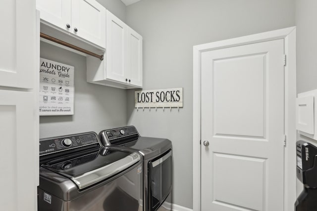 washroom with washer and clothes dryer and cabinets