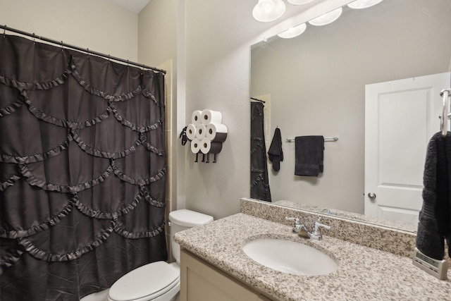 bathroom featuring a shower with curtain, vanity, and toilet