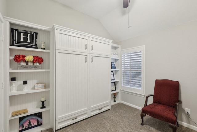 living area with carpet floors, vaulted ceiling, and ceiling fan