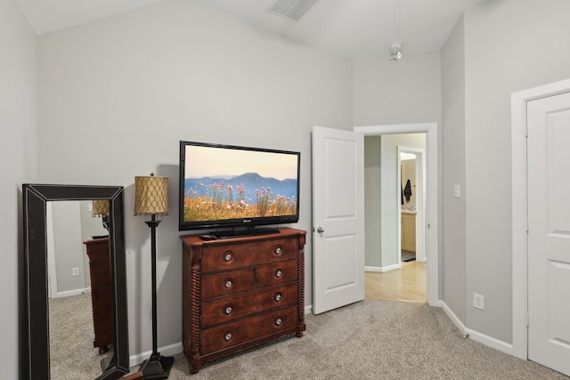 carpeted bedroom featuring a towering ceiling