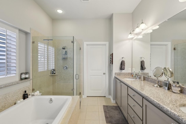 bathroom featuring tile patterned flooring, vanity, and independent shower and bath