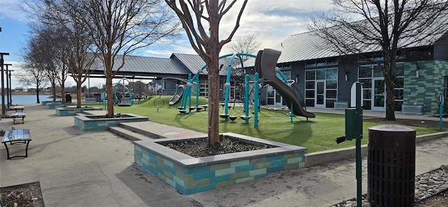 view of jungle gym with a water view and a yard