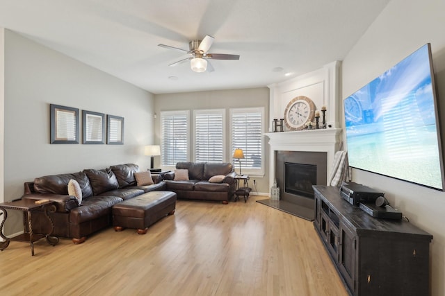 living room featuring light hardwood / wood-style flooring and ceiling fan