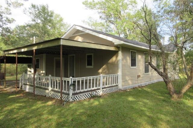 view of side of home with a lawn