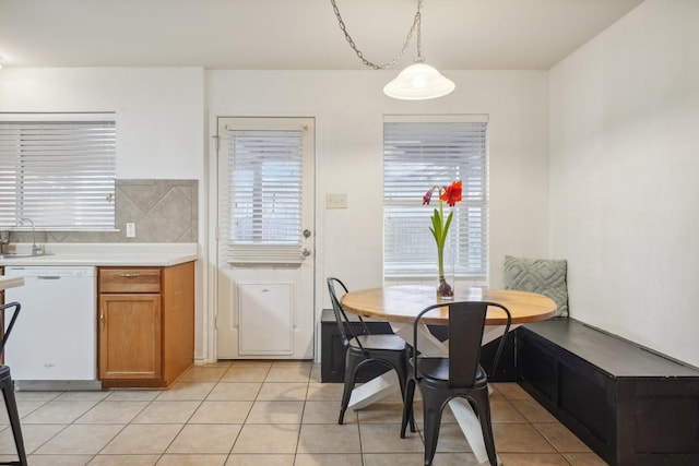 tiled dining room featuring sink