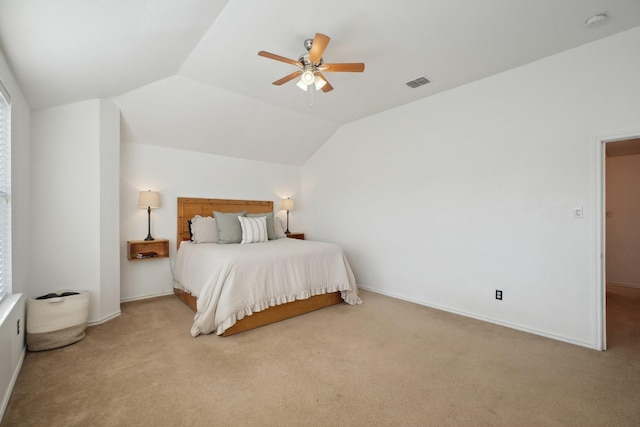 carpeted bedroom with ceiling fan and vaulted ceiling