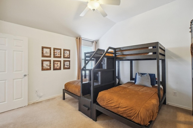 bedroom with ceiling fan, vaulted ceiling, and carpet