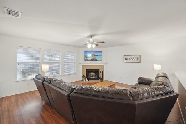 living room with a fireplace, dark hardwood / wood-style floors, and ceiling fan