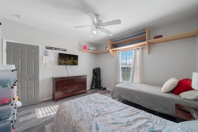 bedroom with hardwood / wood-style floors and ceiling fan