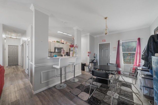 dining room featuring dark hardwood / wood-style flooring and crown molding