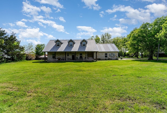 view of front of house with covered porch and a front lawn