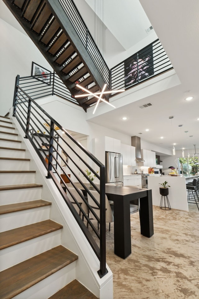 staircase featuring a high ceiling