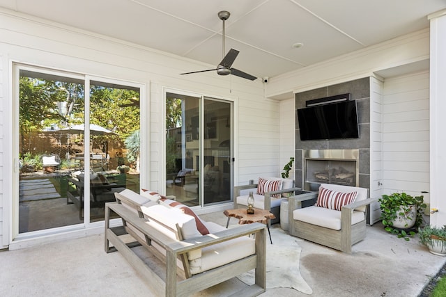 view of patio featuring ceiling fan and a fireplace