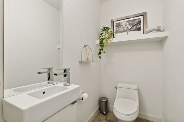 bathroom featuring sink and toilet