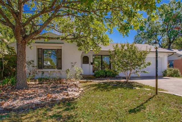 view of front of house with a front yard and a garage