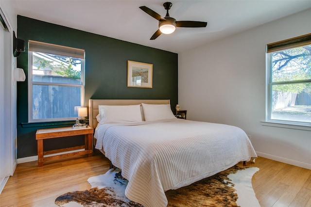 bedroom with ceiling fan and light hardwood / wood-style flooring