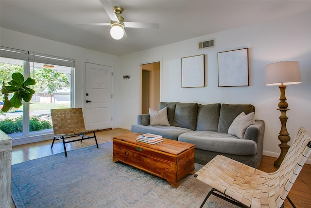 living room with ceiling fan and hardwood / wood-style floors