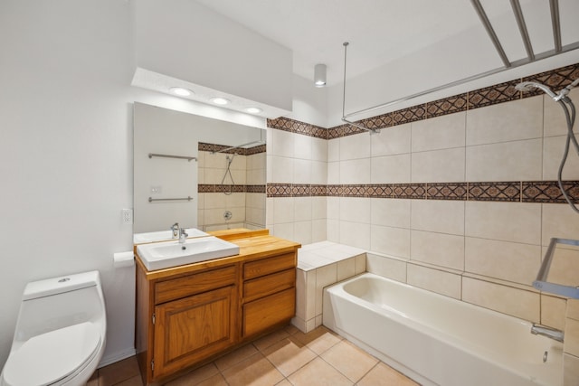 full bathroom with tiled shower / bath, vanity, toilet, and tile patterned flooring