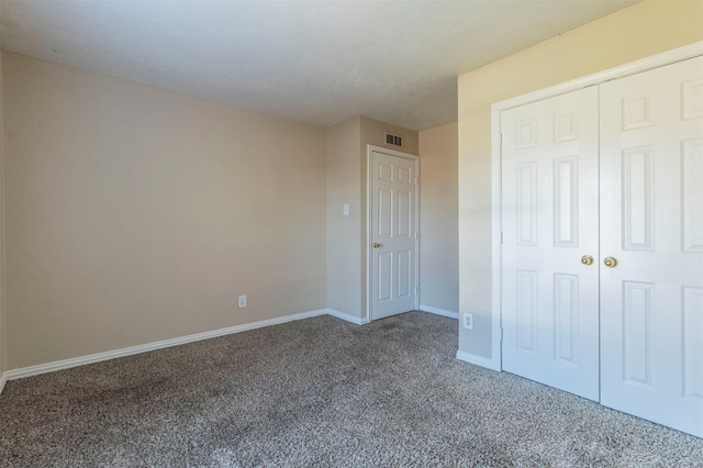 unfurnished bedroom featuring a closet and carpet