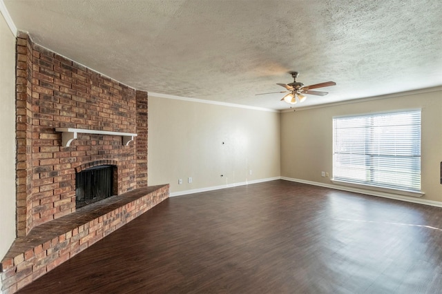 unfurnished living room featuring a textured ceiling, a brick fireplace, ceiling fan, and ornamental molding