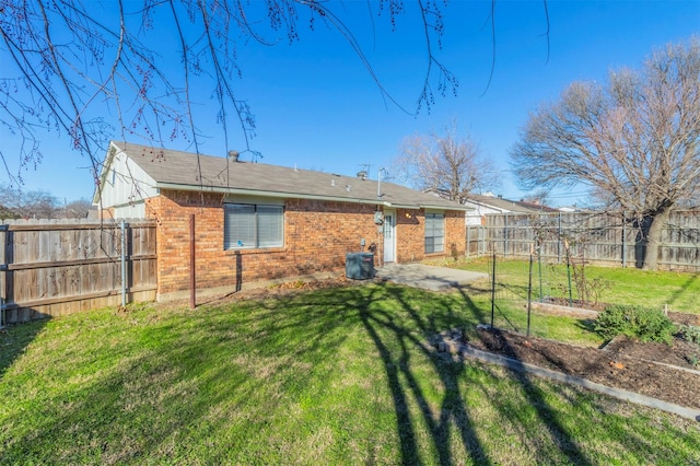 back of property featuring central AC, a yard, and a patio area