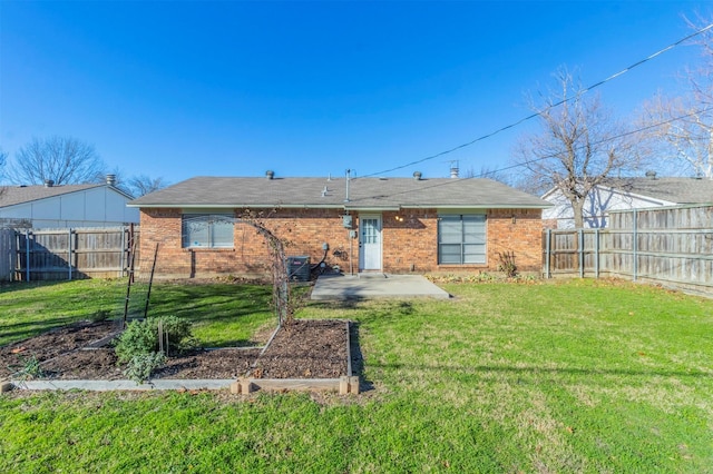 rear view of property featuring a yard and a patio area