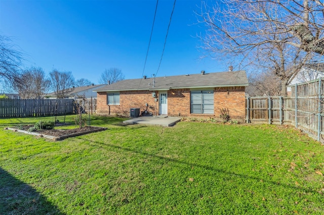 back of property with a patio, a yard, and central AC