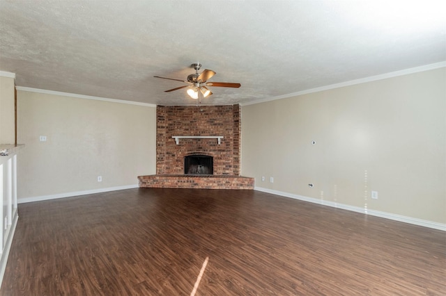 unfurnished living room featuring ceiling fan, ornamental molding, a textured ceiling, dark hardwood / wood-style flooring, and a brick fireplace