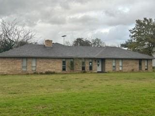 back of house with a yard