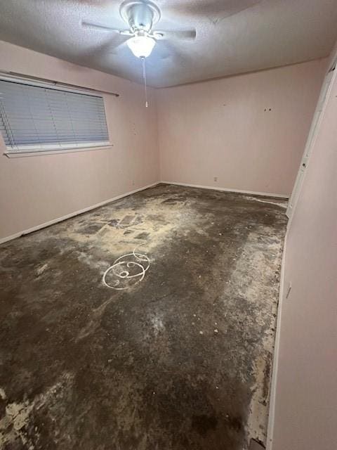 interior space with a textured ceiling and concrete flooring