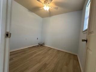 laundry room with ceiling fan and wood-type flooring