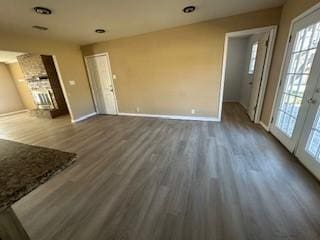 unfurnished living room featuring dark wood-type flooring