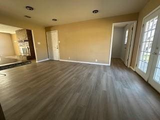 unfurnished living room with dark hardwood / wood-style floors