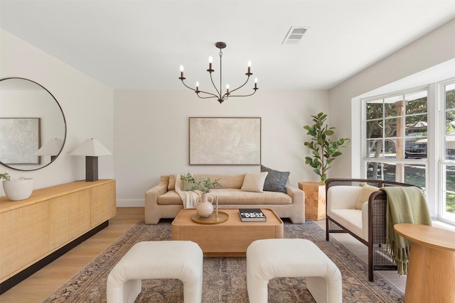 living room featuring hardwood / wood-style floors and an inviting chandelier