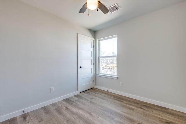 unfurnished room with ceiling fan and light wood-type flooring