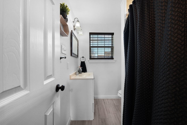 bathroom featuring vanity and toilet