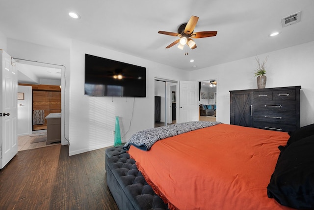 bedroom with ceiling fan, dark hardwood / wood-style floors, ensuite bathroom, and a closet